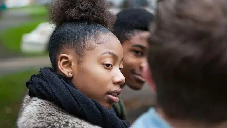 young black teens sitting outside