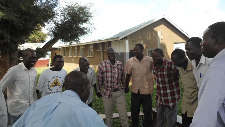 group of Ugandan men standing in circle